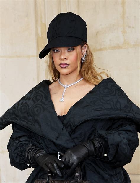 Rihanna Wears Black Belted Dress, Jacket, and Diamonds at .